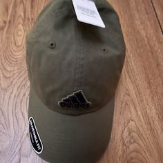 Adidas Olive Green Hat Adidas Cotton Hat With Curved Brim, Adidas Cotton Hats With Curved Brim, Adjustable Adidas Cotton Hat, Adidas Adjustable Baseball Cap, Casual Khaki Visor Hat, Adidas Sporty Hats For Spring, Adidas Casual Baseball Cap For Outdoor, Adidas Casual Curved Brim Hat, Adidas Casual Hat With Curved Brim