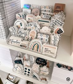 a white shelf filled with lots of different types of stickers and magnets on it