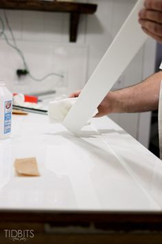 a person is cleaning the counter top with a sponge