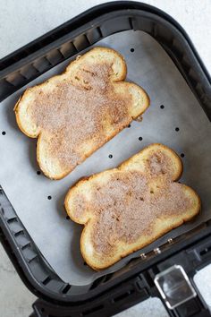 two pieces of bread sitting in an air fryer