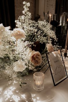 a table with flowers and candles on it