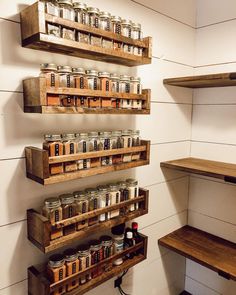 the shelves are filled with jars and cans on them, along with some wooden crates