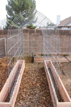 the garden is being constructed with wire and wood