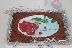 there is a chocolate cake in the shape of a rose with words i am sorry on it