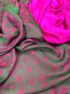 pink and green fabric laying on top of each other