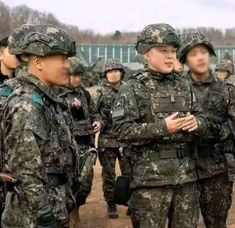 some soldiers are standing together and talking to each other