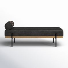 an upholstered bench with a round cushion on it's back and legs