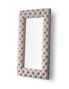 a mirror that is on the wall with a light pink frame and white back ground