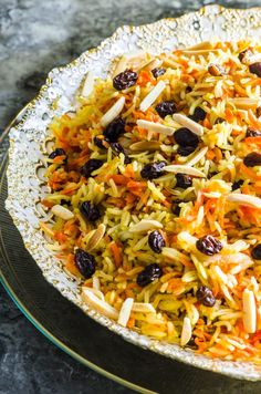 a bowl filled with rice and raisins on top of a table