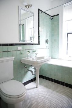 a white toilet sitting next to a bathroom sink