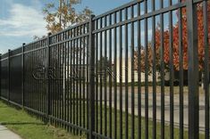 a black metal fence on the side of a road