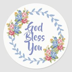 a round sticker with the words, god bless you in blue and pink flowers