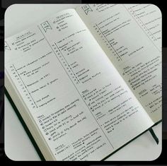 an open notebook with some writing on the pages and numbers in each page, sitting on top of a white table