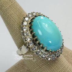 Beautiful sleeping beauty turquoise diamond ring with perfect robins egg blue color! Brilliant round diamonds encircle the turquoise.Ring Size: 6.5Total Weight: 16.8 gramsPrecious Metal: 18k goldPrecious stones:-Sleeping Beauty Turquoise Center Stone: 14mm x 22mm-White Round Diamonds: 1 carats Fine Jewelry Turquoise Diamond Ring, Turquoise Blue Diamond Ring With Center Stone, Oval Diamond Turquoise Ring For Formal Occasions, Formal Turquoise Diamond Ring With Gemstone, Formal Oval Turquoise Ring With Diamond, Formal Turquoise Diamond Ring, Luxury Turquoise Diamond Ring With Center Stone, Oval Turquoise Ring With Diamond Accents, Elegant Turquoise Cabochon Diamond Ring