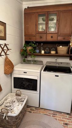 a white stove top oven sitting inside of a kitchen next to a washer and dryer