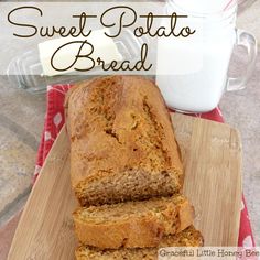 sliced loaf of sweet potato bread sitting on a cutting board next to a glass of milk