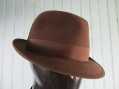 Vintage french trilby in chocolate brown with brown hat band. The inside band is leather.  Good condition. Dimensions: Circumference: 22 1/2 Inches. Height: 4 Inches. Brim to brim: 11 Inches. Made by FLETCHET Classic Brown Formal Hat Band, Fitted Brown Felt Hat With Flat Brim, Formal Fitted Brown Fedora, Western Style Brown Hat Bands For Formal Occasions, Fitted Brown Fedora For Winter, Classic Brown Fedora Hat, Brown Formal Hat With Short Brim, Formal Brown Brimmed Hat, Classic Brown Hat Bands For Winter