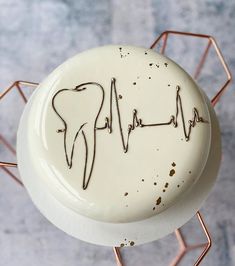 a white cake with chocolate sprinkles and a stethoscope on it