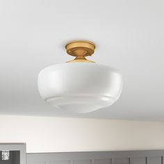 a white and gold ceiling light in a room