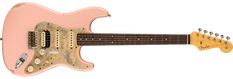 an electric guitar with a pink body and neck