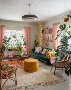 a living room filled with furniture and lots of plants