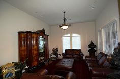 a living room with leather furniture and large windows