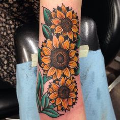 a sunflower tattoo is shown on the arm