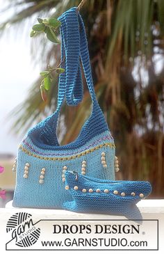 a crocheted purse hanging from a tree branch