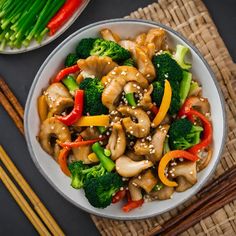 a white bowl filled with chicken and veggies next to some chopsticks