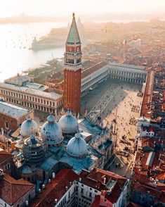 an aerial view of a city with buildings and a large clock tower in the center