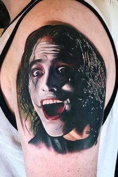 a man's arm with an image of the joker on it