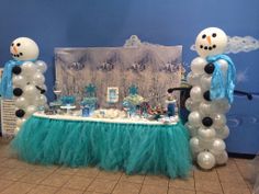 a table with balloons and snowmen on it