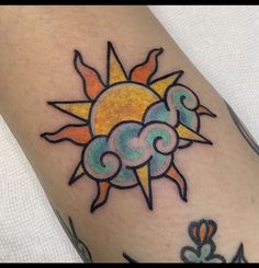 a sun and clouds tattoo on the arm