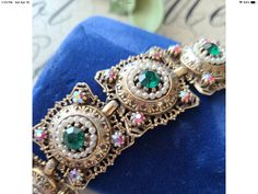 "Vintage Ornate AB Emerald Green Rhinestones Statements Wrist Bracelet This lovely piece can be worn on any occasion and is absolutely beautiful in the light, both inside and out, the perfect gift for anyone who loves vintage jewelry. Colors and Shades may vary due to Lighting - Measures Approx. 7\" - Each order comes shipped in a small drawstring pouch, all ready for gifting. -If you are wanting to have this mailed as a gift to a special someone, please write their address in the note section, Bohemian Jeweled Bracelets For Wedding, Bohemian Jeweled Wedding Bracelets, Jeweled Round Crystal Bracelet As Gift, Jeweled Crystal Bracelet Gift, Jeweled Round Crystal Bracelet For Gift, Costume Jewelry Jeweled Bracelets For Gift, Jeweled Costume Jewelry Bracelets For Gift, Costume Jewelry Bracelets With Bling For Gifts, Costume Jewelry Crystal Bracelet For Gift