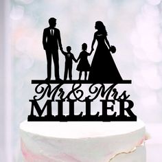 a cake topper that says mr and mrs miller with a family silhouette on it