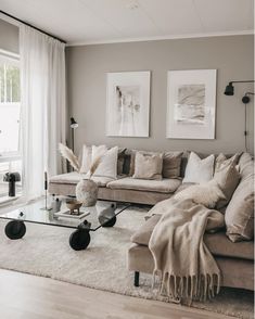 a living room filled with lots of furniture next to a glass coffee table and window