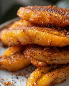 some fried bananas on a white plate with seasoning