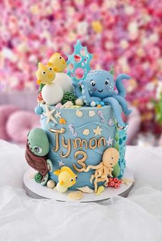 there is a blue cake with animals on it