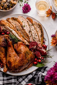 a turkey with cranberries and herbs on a plate