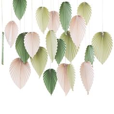 several green and white paper leaves hanging from strings