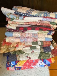 a stack of quilts sitting on top of a table