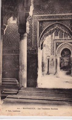 an old photo of the entrance to a building with arches and doorways in black and white