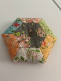 a small patchwork pot holder on a table