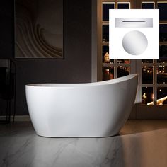 a white bath tub sitting on top of a bathroom floor next to a window with city lights in the background