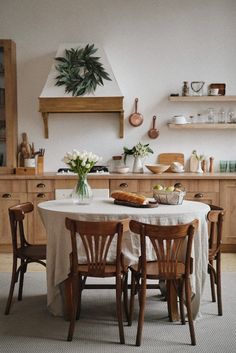 a dining room table with some chairs around it