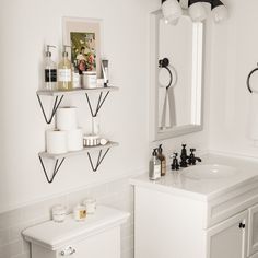 a white bathroom with black and white accessories