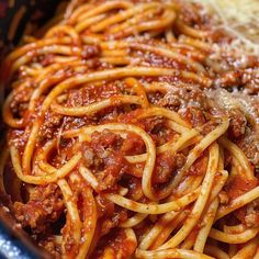 spaghetti with meat and sauce in a blue bowl