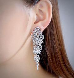 A beautiful pair of bridal earrings that is sure to make a bold statement on your Wedding Day! Adorned with glowing cubic zirconia that capture the light from every angle with a perfectly translucent appeal, the earrings are rhodium/rose gold plated for a bright finish which enhances the intricate detailing and conveys a modern take on old elegance. Length of the earring is 2.4" (approx. 6.1cm); Width: 0.7" (approx. 1.8cm); Weight: 12g. Available in Silver and Rose Gold finishes. To make your ch Cubic Zirconia Bridal Earrings, Bridal Earrings, On Your Wedding Day, Exquisite Design, Rose Gold Plates, Gold Finish, Crystal Rhinestone, Wedding Jewelry, Ear Cuff