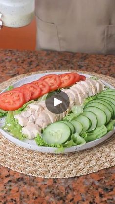 a plate with sliced cucumbers and tomatoes on it