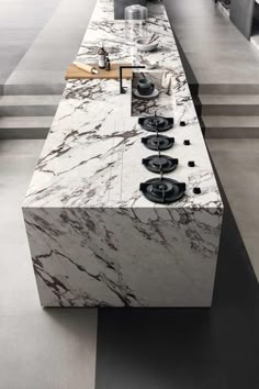 a kitchen with marble counter tops and stoves